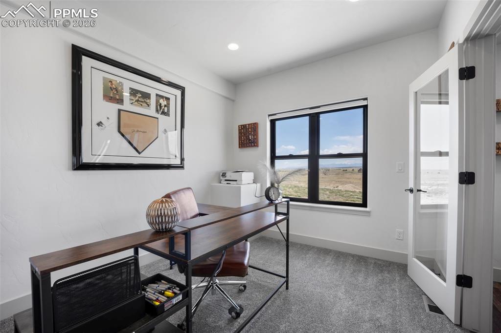 16535 Sweet Road Peyton, CO 80831 - Photo 16 of 45 a work room with furniture and windows