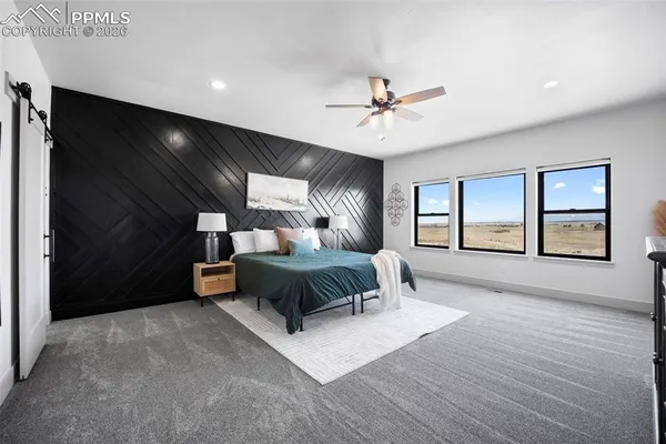 a spacious bedroom with a large bed and windows