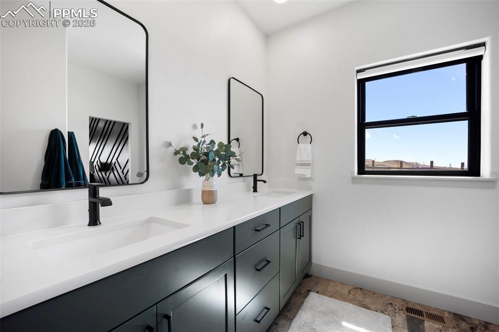 16535 Sweet Road Peyton, CO 80831 - Photo 22 of 45 a bathroom with a sink and a mirror