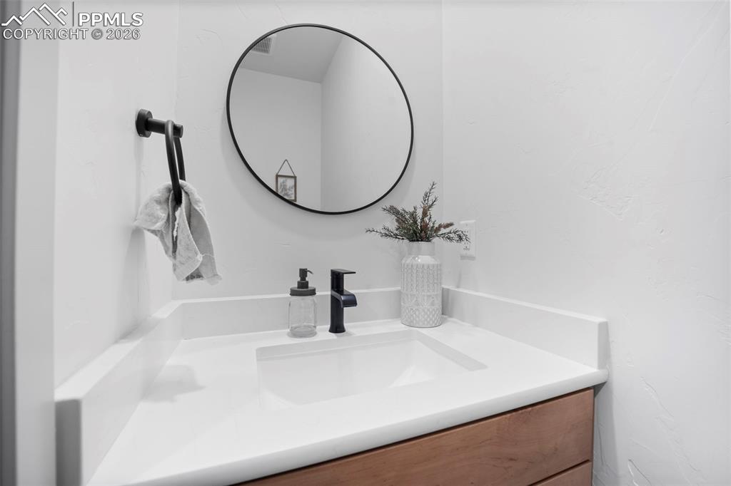 16535 Sweet Road Peyton, CO 80831 - Photo 25 of 45 a bathroom with a sink and a mirror