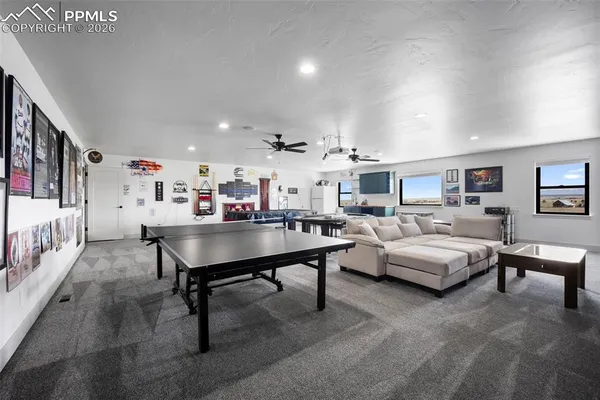 a living room with furniture and a view of kitchen