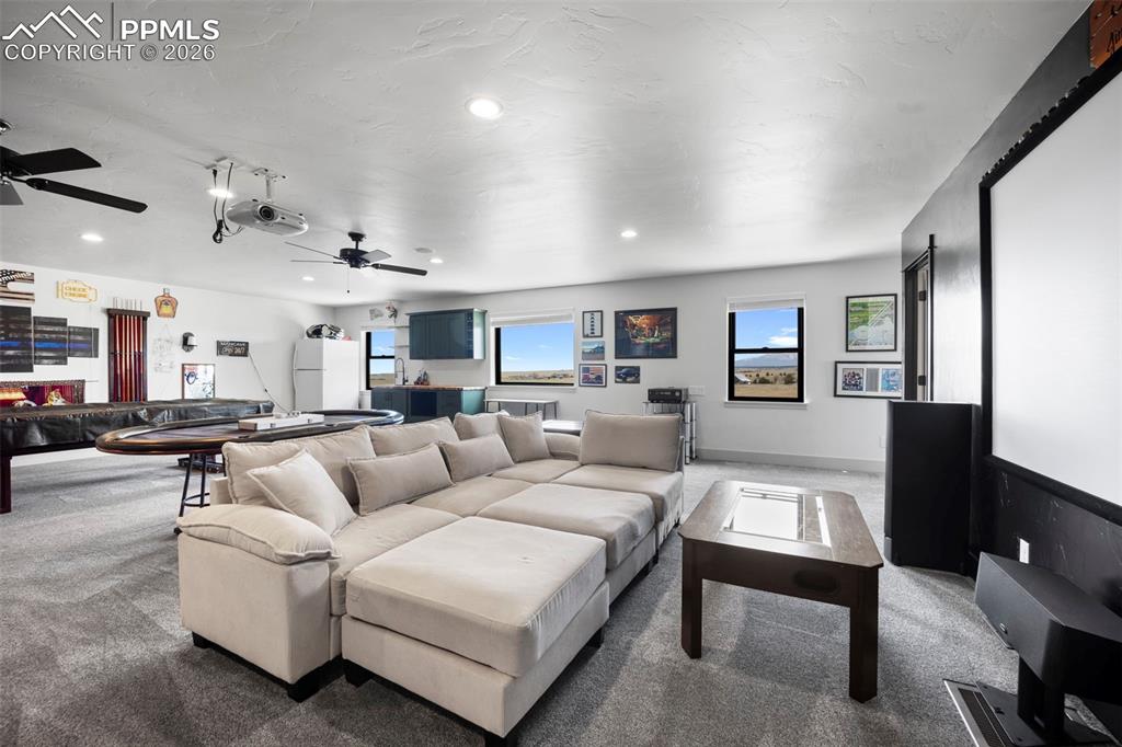 16535 Sweet Road Peyton, CO 80831 - Photo 34 of 45 a living room with furniture and a view of kitchen