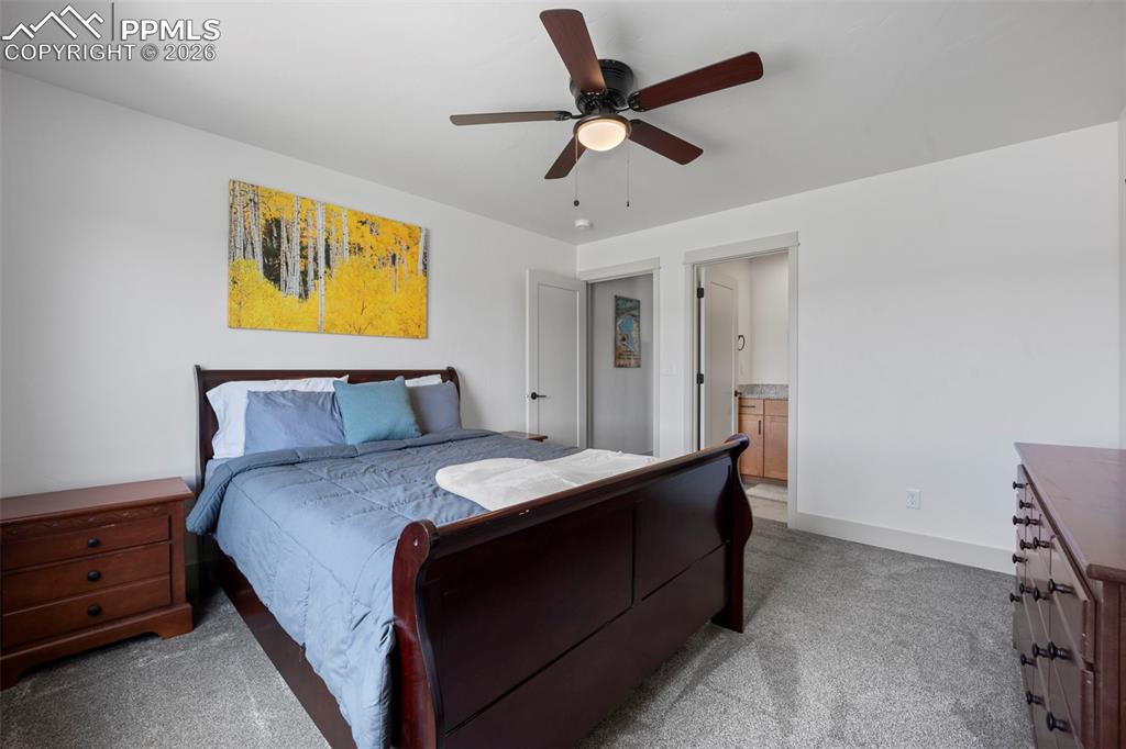 16535 Sweet Road Peyton, CO 80831 - Photo 36 of 45 a bedroom with a bed and a chandelier