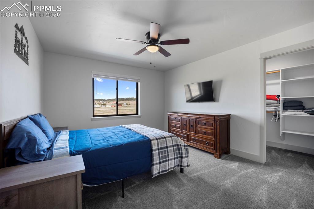 16535 Sweet Road Peyton, CO 80831 - Photo 37 of 45 a bedroom with a bed and a dresser