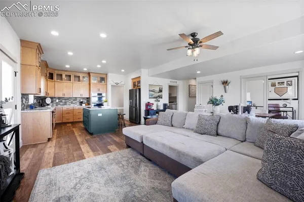 a living room with furniture and kitchen view