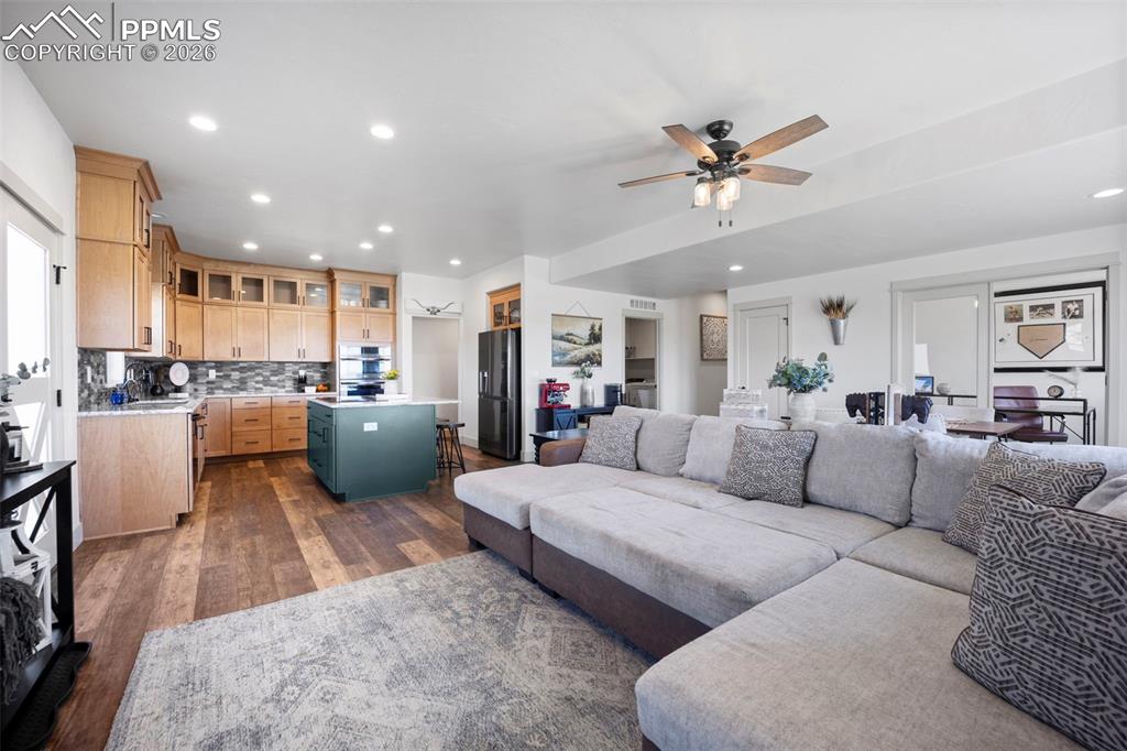 16535 Sweet Road Peyton, CO 80831 - Photo 5 of 45 a living room with furniture and kitchen view