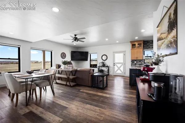 a living room with lots of furniture and kitchen view