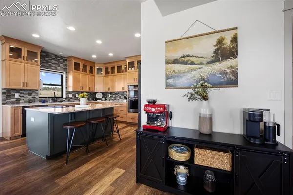 a kitchen with stainless steel appliances granite countertop a stove a refrigerator and a microwave