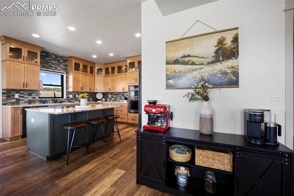 16535 Sweet Road Peyton, CO 80831 - Photo 9 of 45 a kitchen with stainless steel appliances granite countertop a stove a refrigerator and a microwave