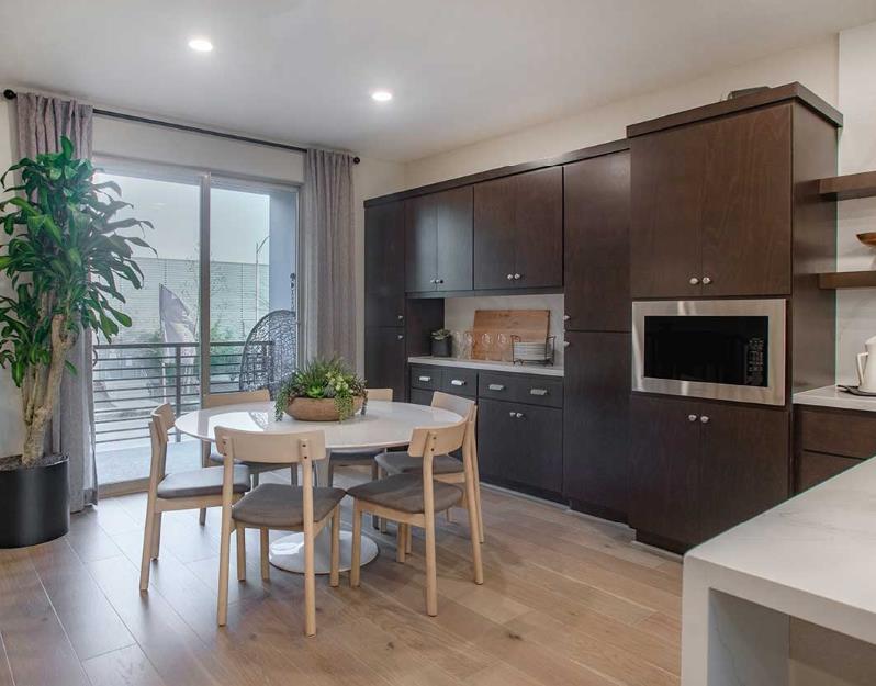 6617 Optimun Loop San Jose, CA 95119 - Photo 5 of 8 a kitchen with a table chairs refrigerator and microwave