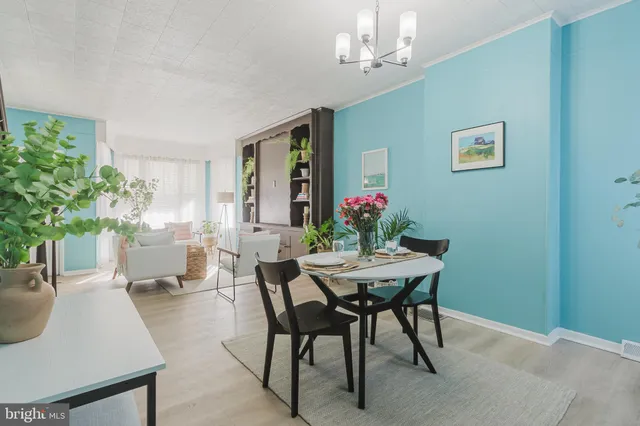 a view of a dining room with furniture and chandelier