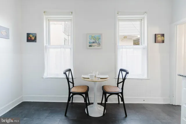 a view of a dining room with furniture and a window