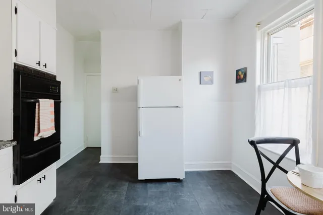 a view of room with window and wooden floor
