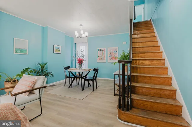 a dining room with furniture and wooden floor