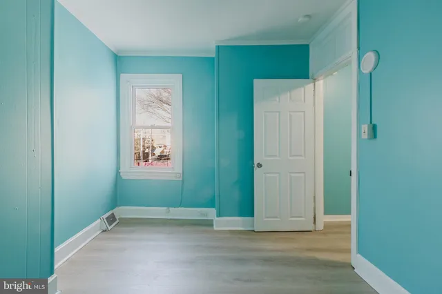 an empty room with windows and closet