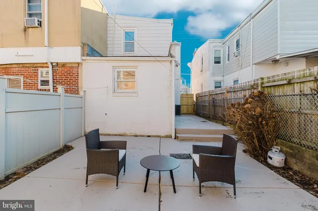a backyard of a house with outdoor seating