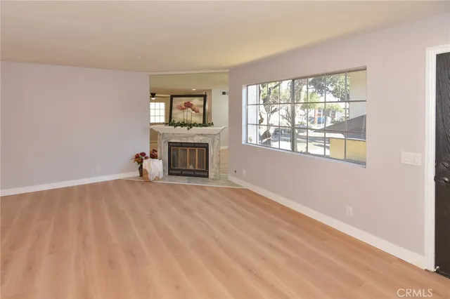 a living room with a fireplace and a potted plant