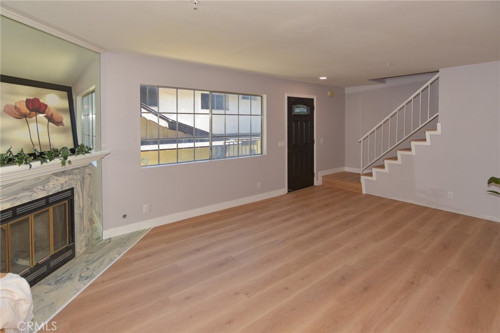 1712 Pepper Street, Unit A Alhambra, CA 91801 - Photo 3 of 39 a view of empty room with wooden floor and fan