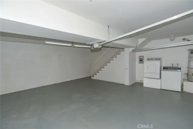 a view of staircase with lots of frames on wall and entryway