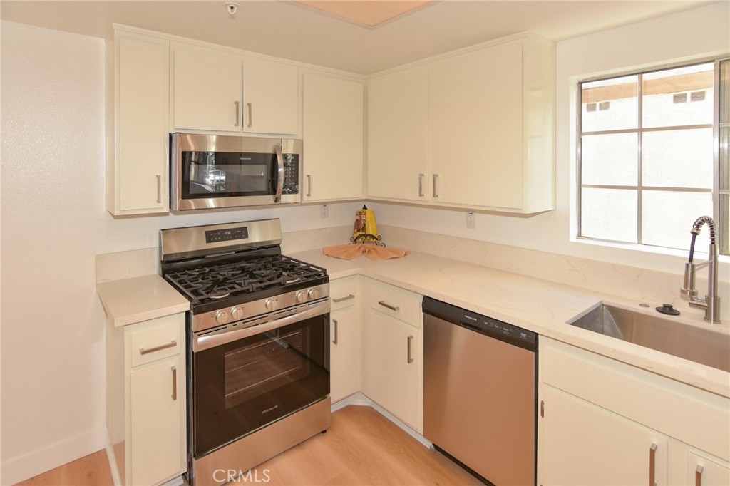1712 Pepper Street, Unit A Alhambra, CA 91801 - Photo 4 of 39 a kitchen with granite countertop a stove sink and microwave