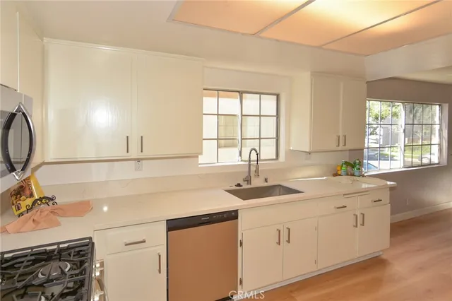 a kitchen with a sink stove and cabinets