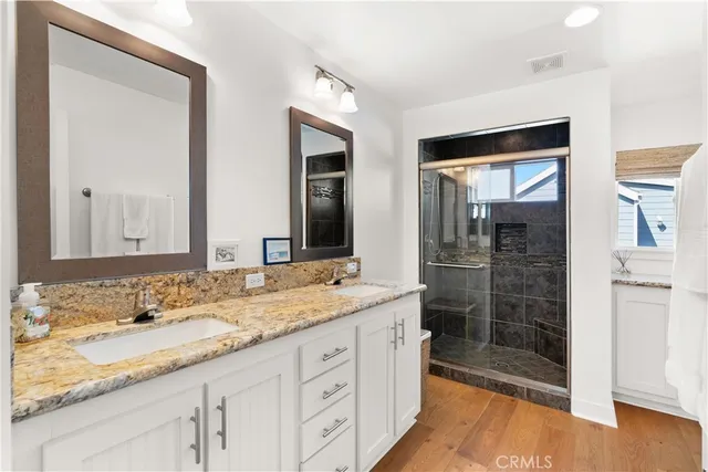a bathroom with a granite countertop sink mirror and double