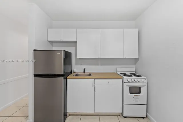 a utility room with sink dryer and washer