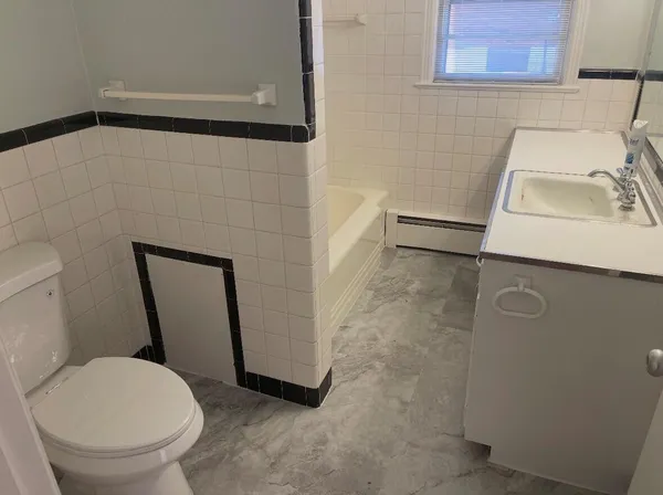 a bathroom with a toilet and a sink