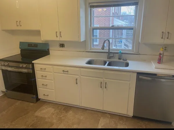 a kitchen with white cabinets and a sink