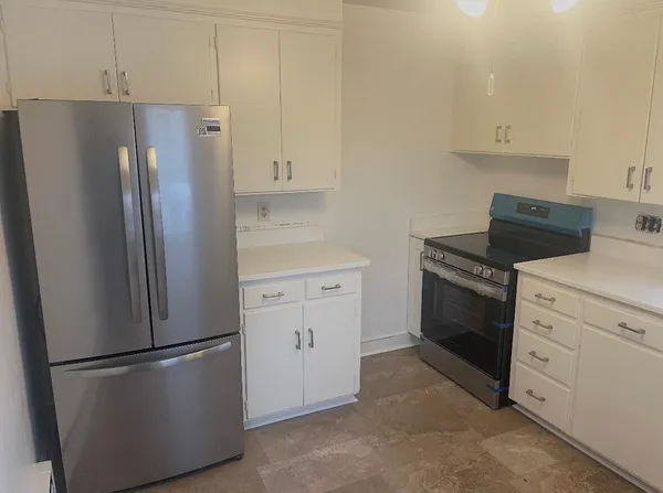 a kitchen with cabinets and stainless steel appliances