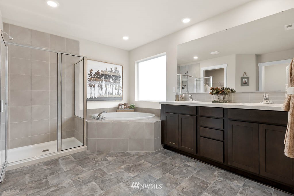 7 211th Street Southeast, Unit P9 Bothell, WA 98021 - Photo 22 of 31 a bathroom with a granite countertop sink mirror and bathtub