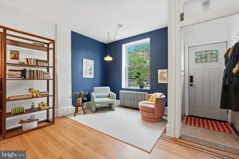 a bedroom with furniture and a book shelf