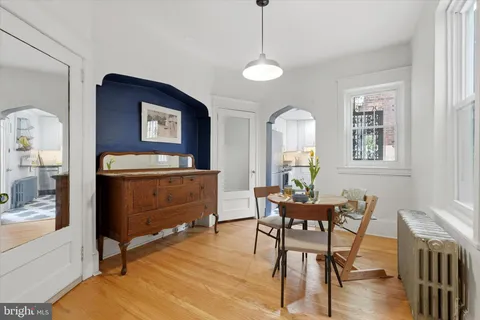 a dining room with furniture and window