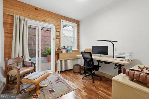 a view of a workspace with furniture and a window