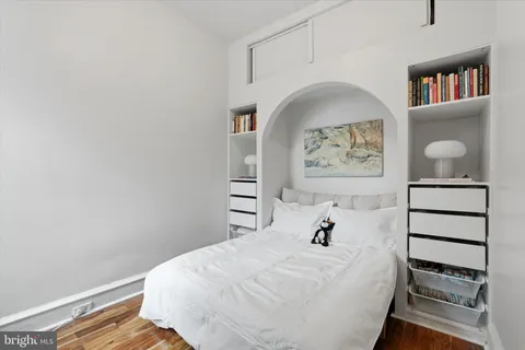 a bedroom with a bed and a painting on the wall