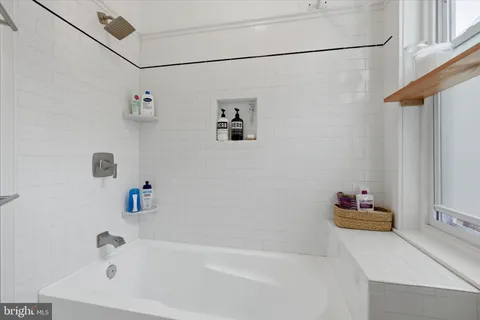 a bathroom with a tub and a shower curtain