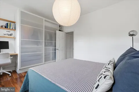 a bedroom with a bed and a mirror