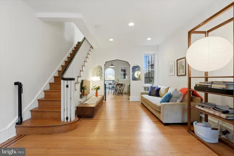 a living room with furniture and a mirror