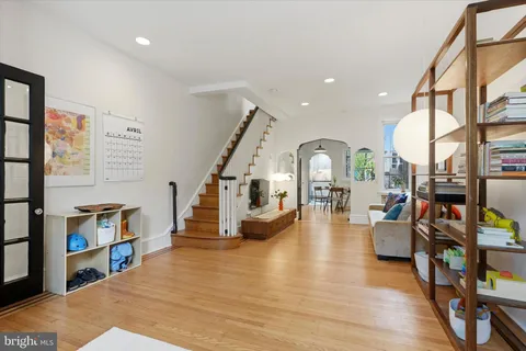 a living room with furniture and a book shelf