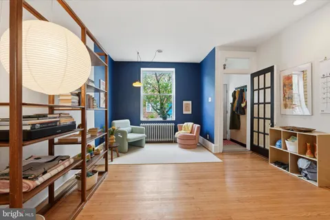 a bedroom with furniture and a book shelf