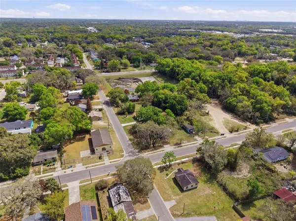 an aerial view of a house with a yard and sitting area