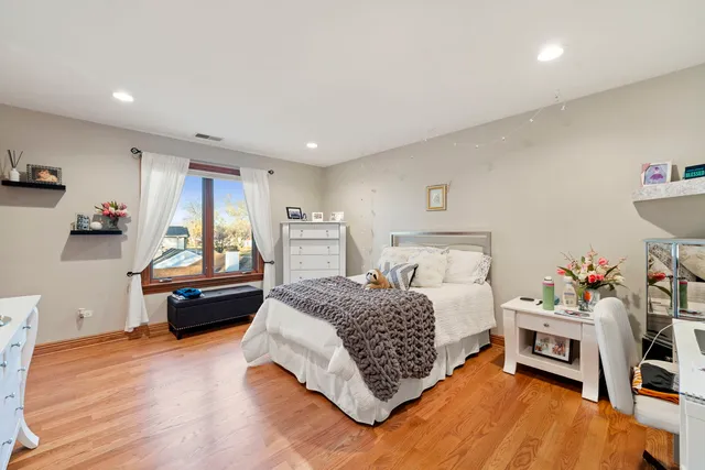 a large bedroom with a bed and a large window