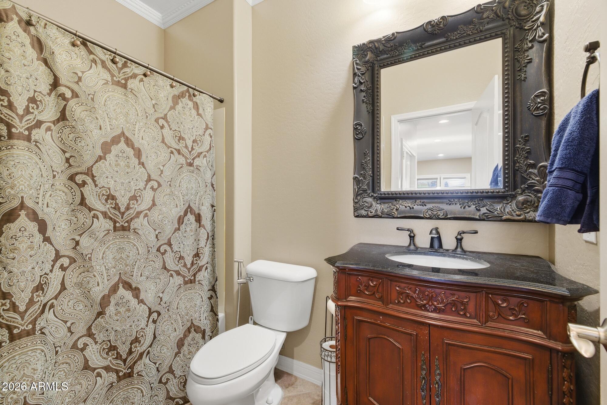 3605 South Danielson Way Chandler, AZ 85286 - Photo 16 of 23 a bathroom with a granite countertop sink and a toilet