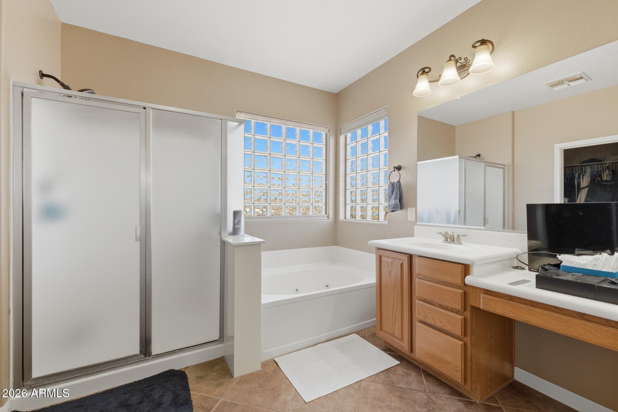3605 South Danielson Way Chandler, AZ 85286 - Photo 17 of 23 a bathroom with a tub sink and mirror