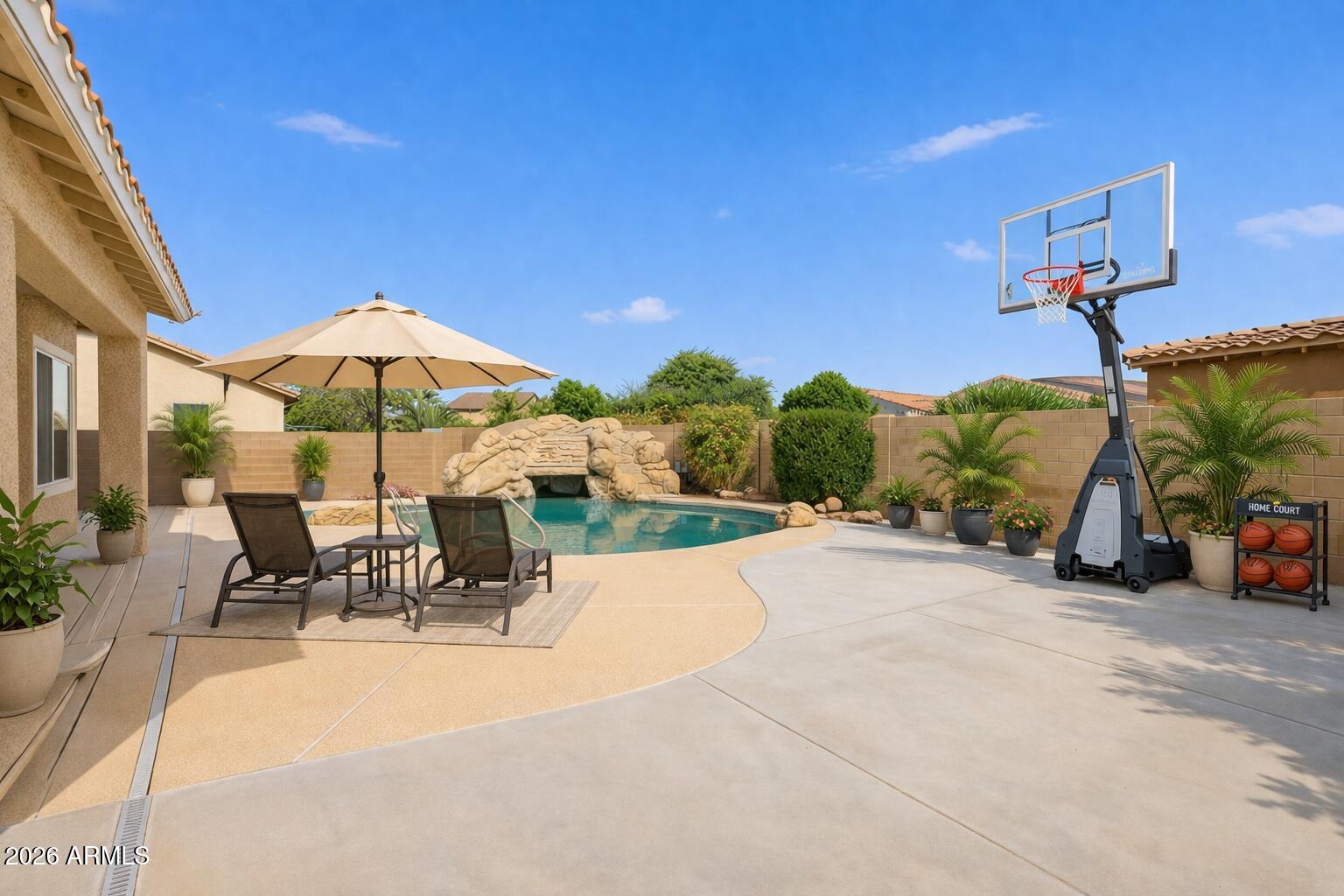 3605 South Danielson Way Chandler, AZ 85286 - Photo 20 of 23 a view of a patio with a table and chairs under an umbrella