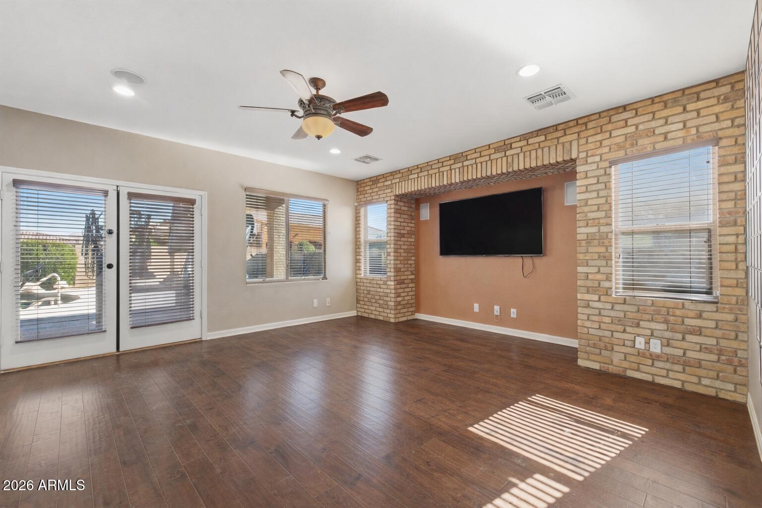 3605 South Danielson Way Chandler, AZ 85286 - Photo 4 of 23 a view of an empty room with a window and wooden floor
