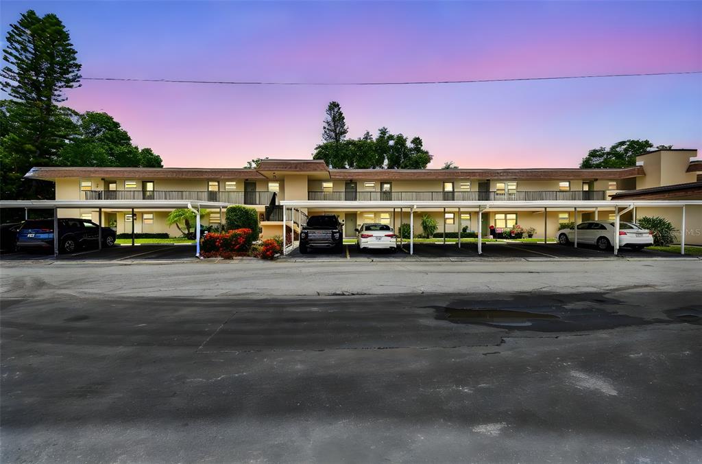 a view of building with cars parked