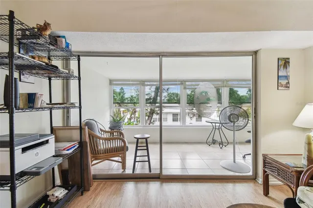 a living room with furniture a flat screen tv and a floor to ceiling window
