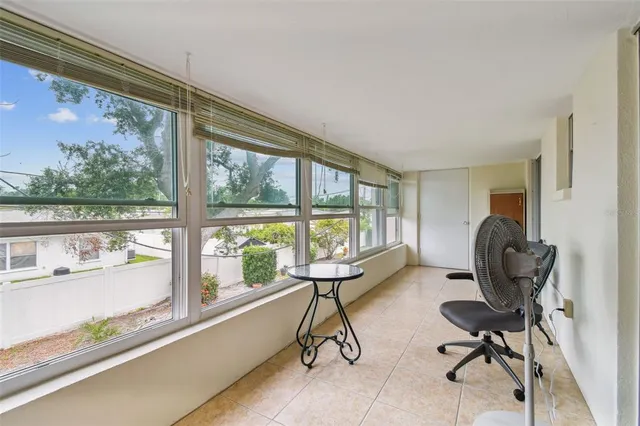 a work room with furniture and a large window