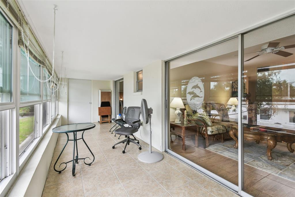 9945 47th Avenue North, Unit 208 St. Petersburg, FL 33708 - Photo 14 of 38 a view of a livingroom with furniture and floor to ceiling window